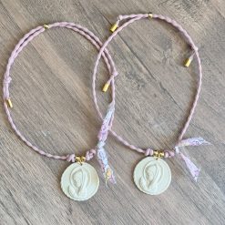 Medallita virgen con elástico rosa empolvado